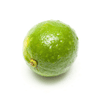 A single, whole lime with small water droplets on its surface, isolated against a white background.